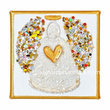Load image into Gallery viewer, A square canvas art piece featuring a glittery angel design with a gold heart on the chest, a gold halo, and multicolored glitter wings, bordered by a gold frame on a white background.